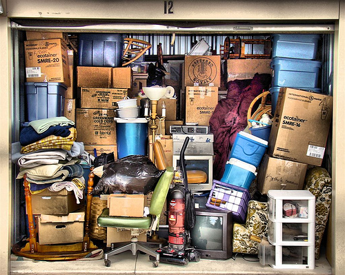 Storage unit packed with boxes, furniture, and household items