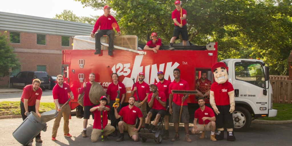 many people posing around work truck