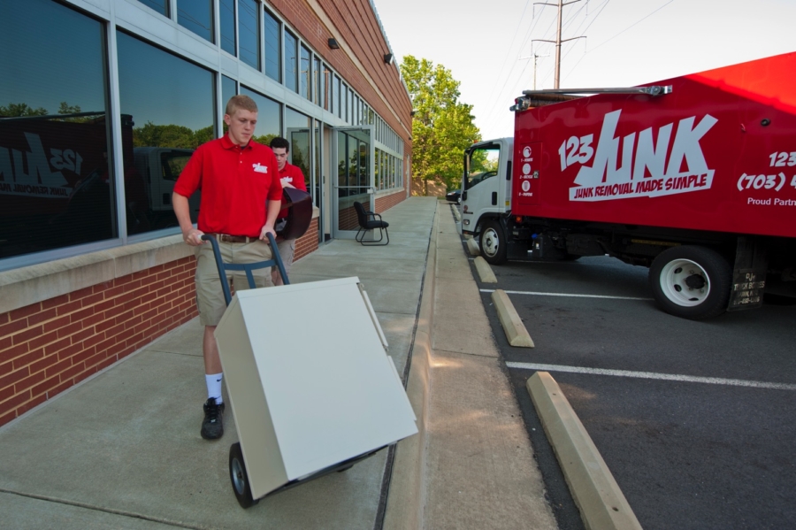 two men in uniform moving office furniture