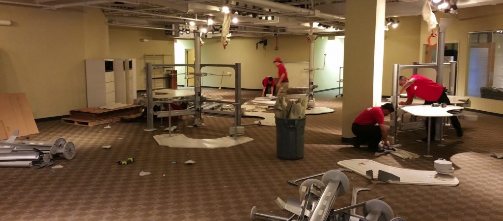 people moving furniture out of an office