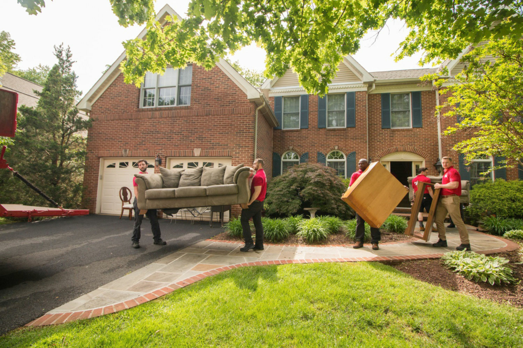 several men moving furniture outside a home