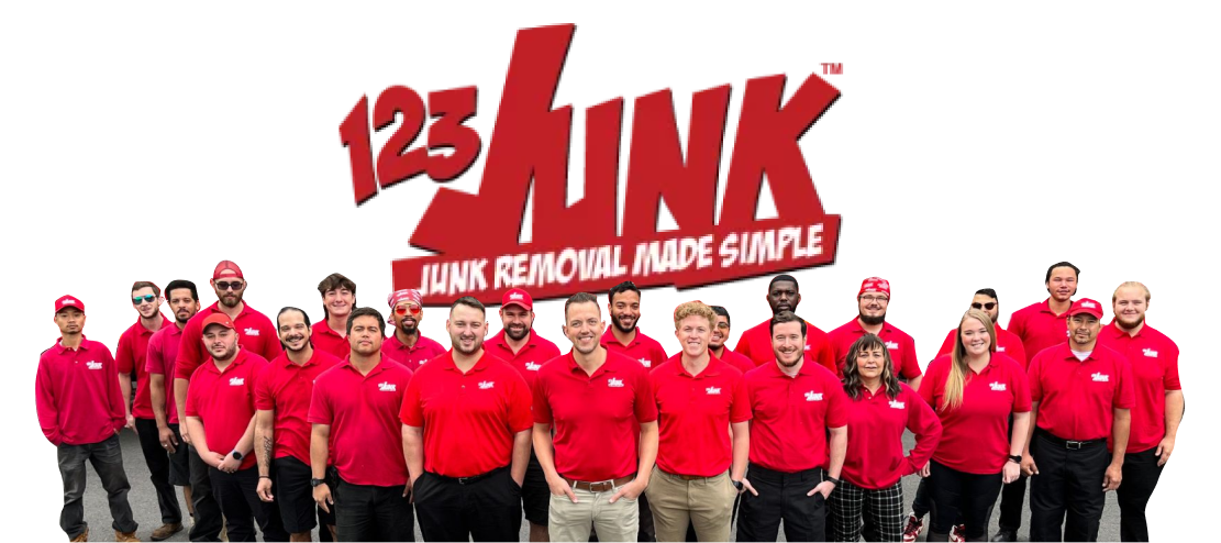 Group of 123JUNK employees in red shirts standing in a line in front of the company logo