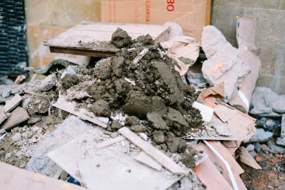 Pile of construction debris with chunks of concrete, wood, and broken materials